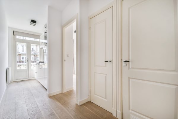 Interior of a spacious room with beautifully laid parquet in an elite house